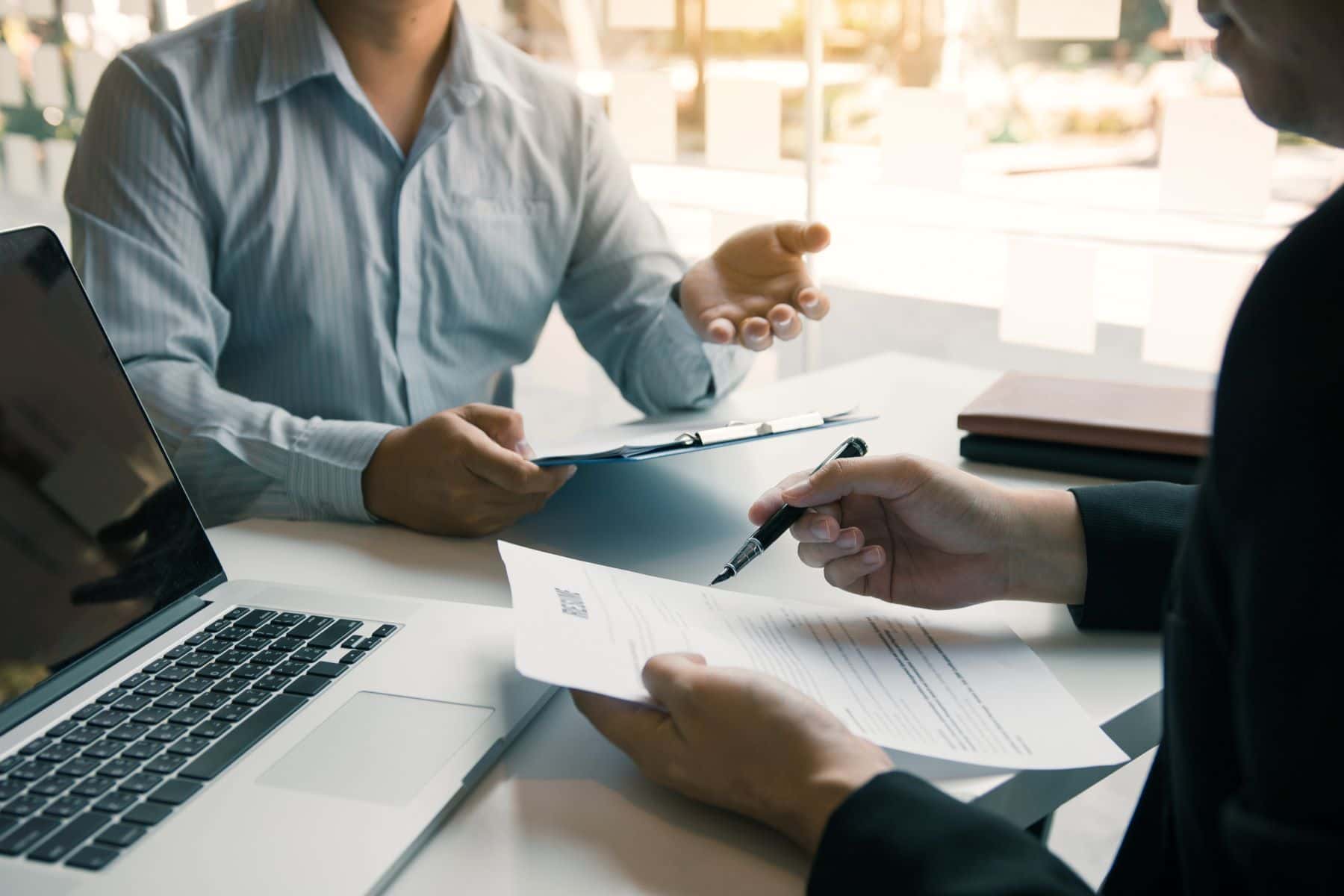 people in an office looking over documents