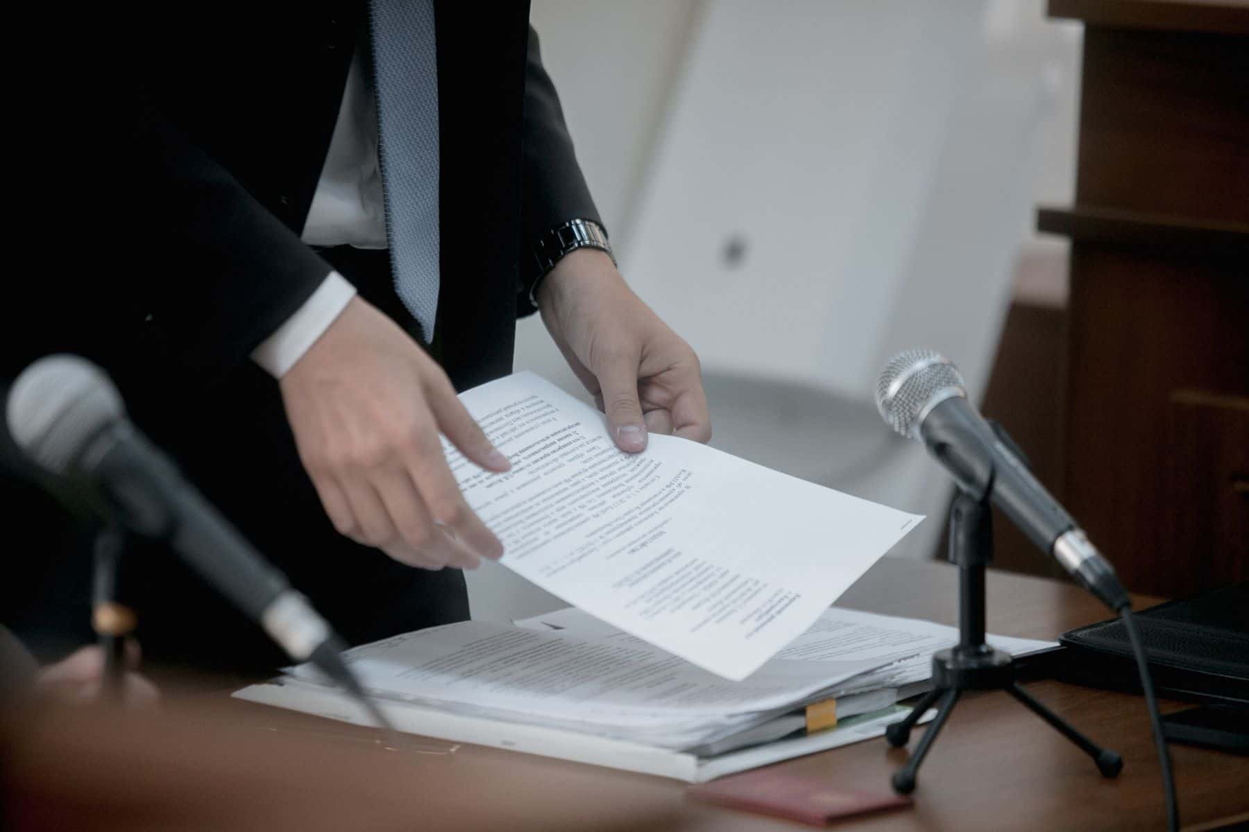 Attorney shuffling documents in courtroom