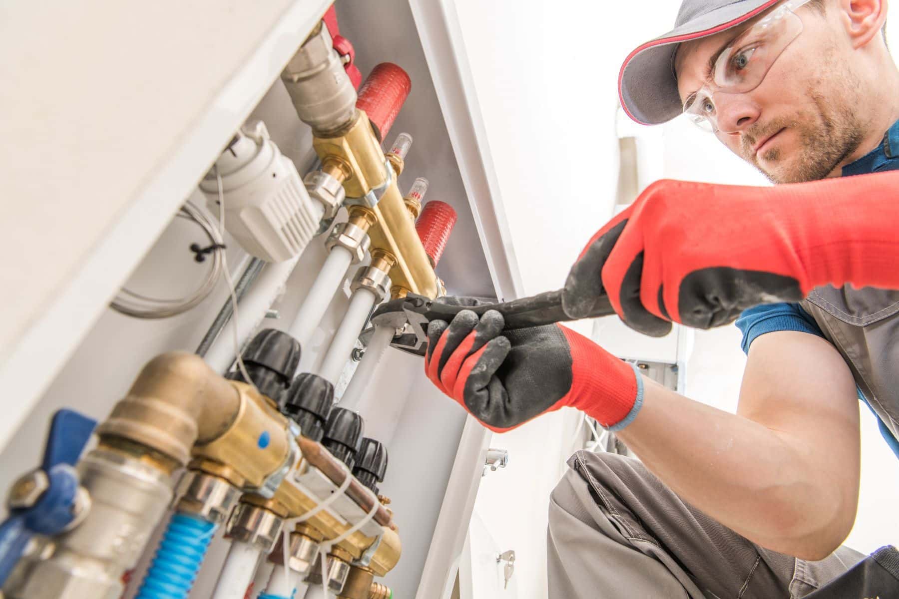 Plumber working on pipes