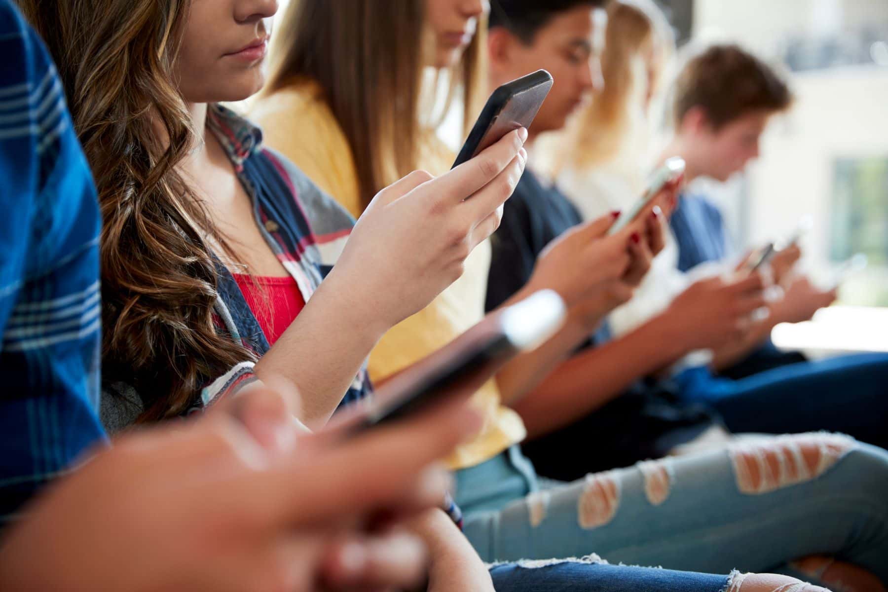 Group of teens using smart phones