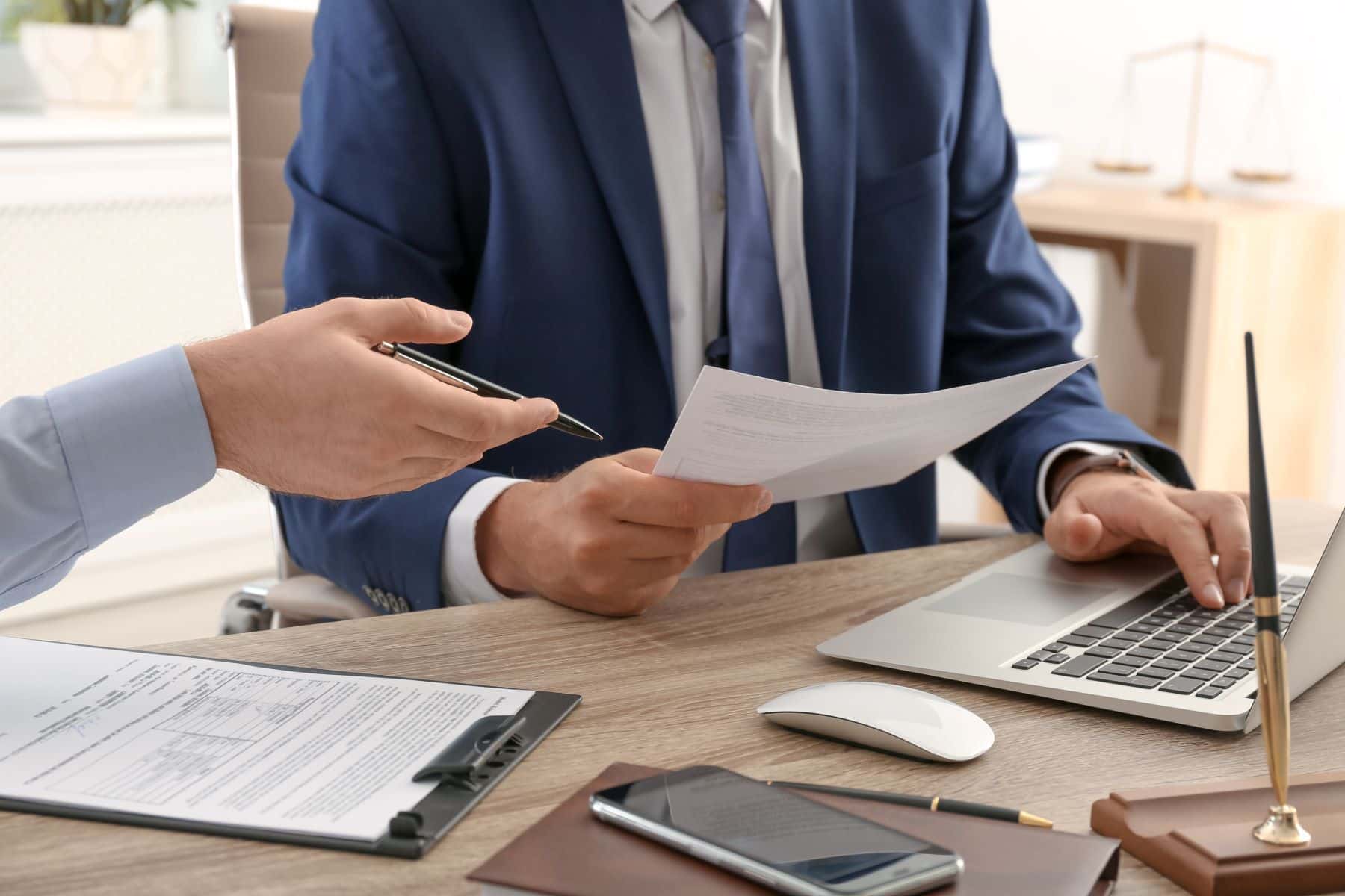 Lawyer using computer while looking at document