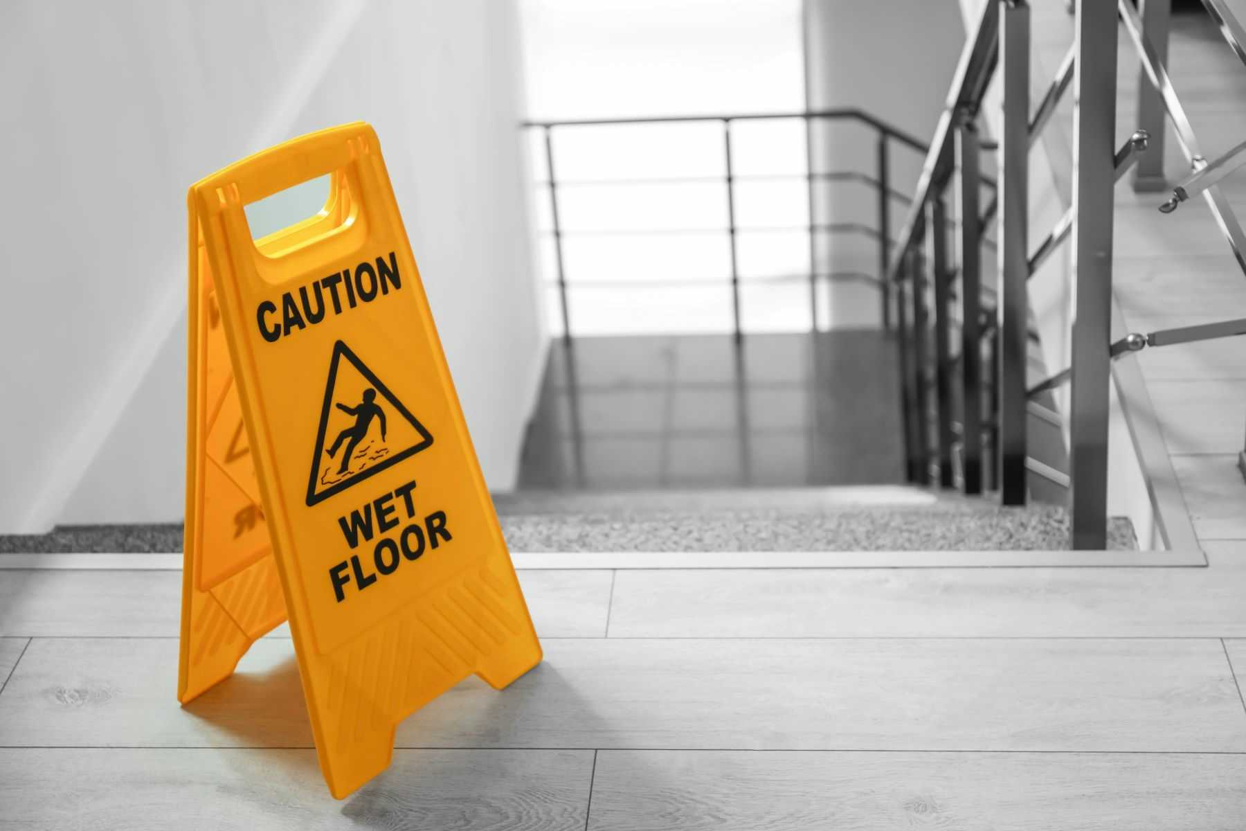 Wet floor sign by stairs