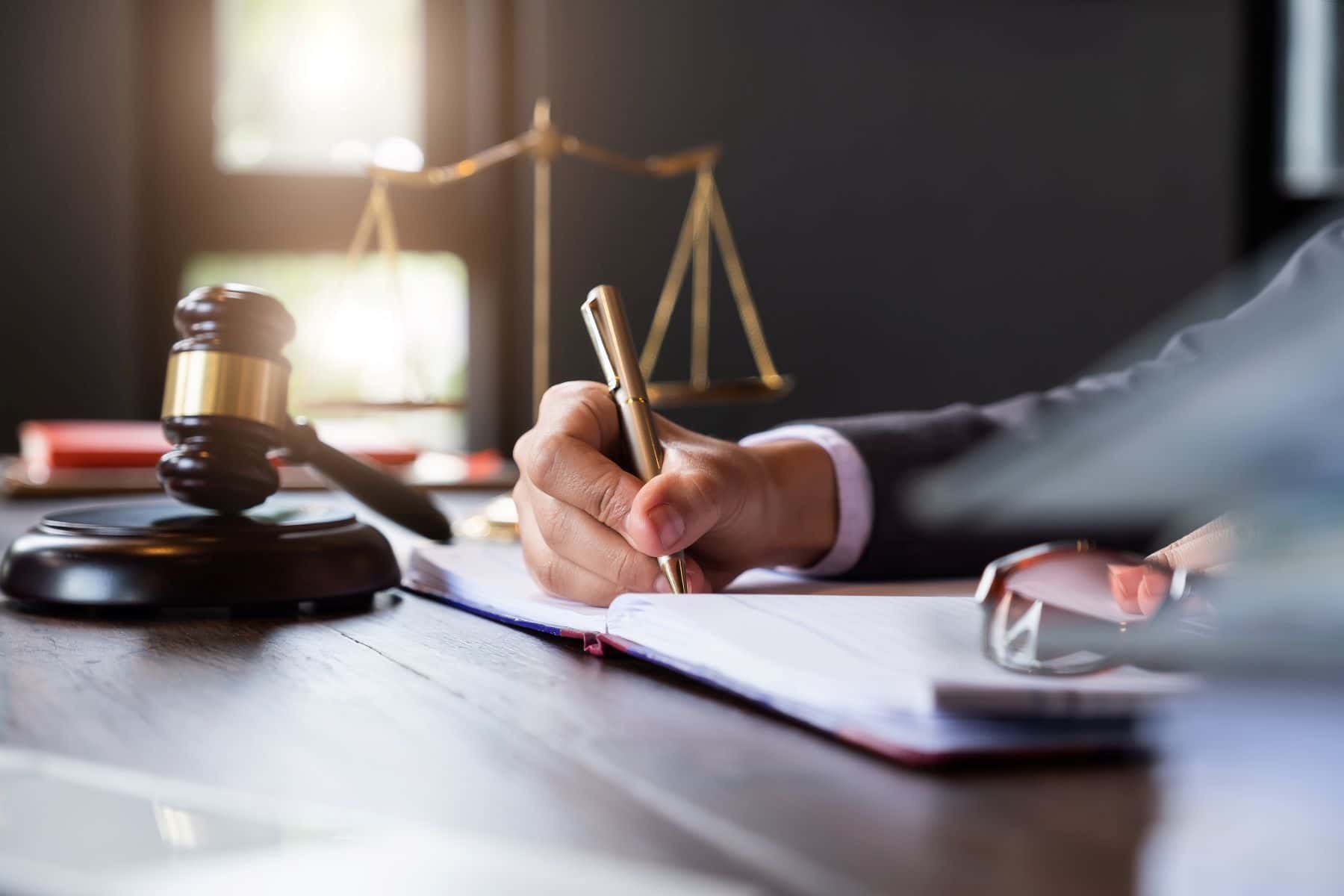 Attorney writing at desk