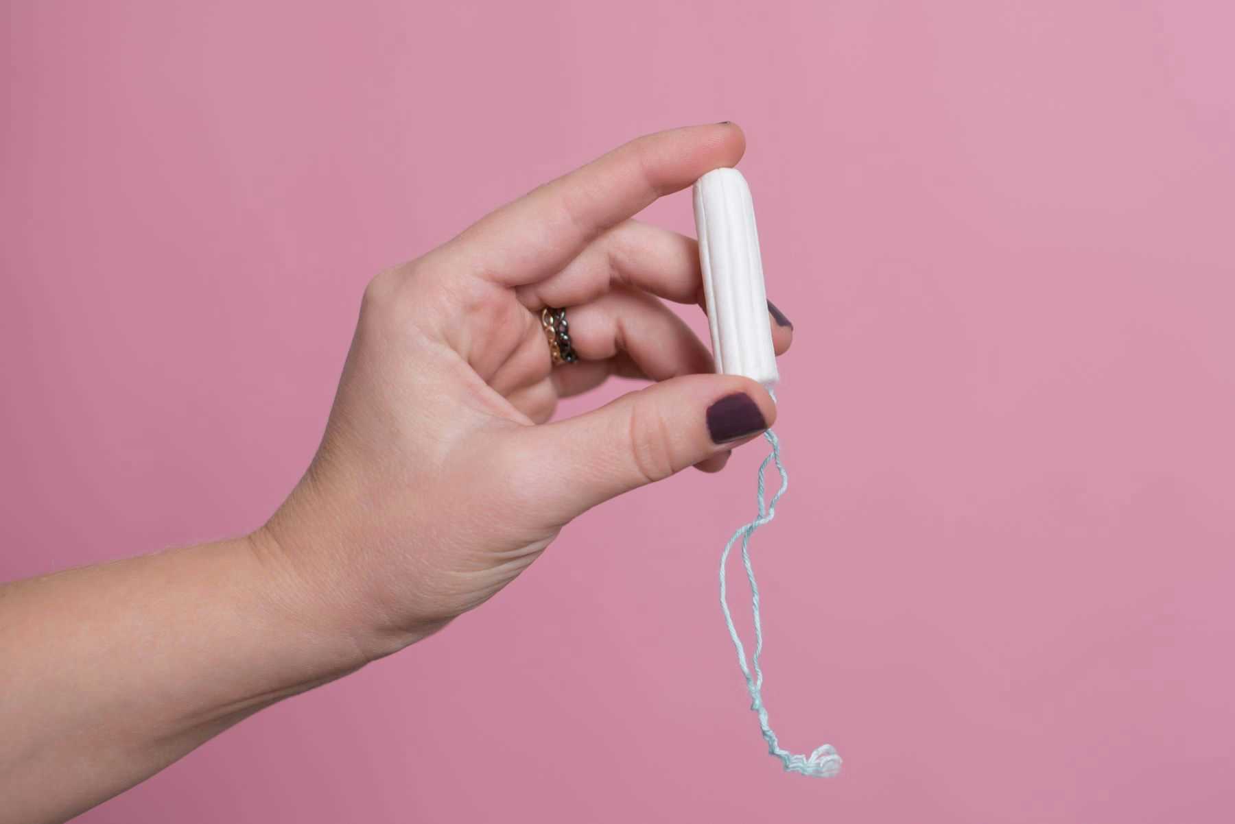 Woman's hand holding a tampon